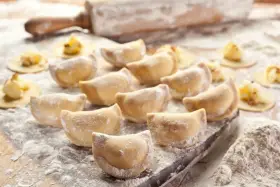 Gotowe do lepienia pierogi, posypane mąką. Zastanawiasz się, jaka mąka na pierogi będzie najlepsza? Ta wygląda idealnie!